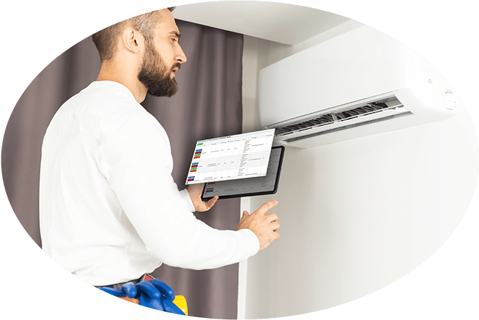 Image of an HVAC service technician with a Flat Rate Pricing Book on a Tablet PC